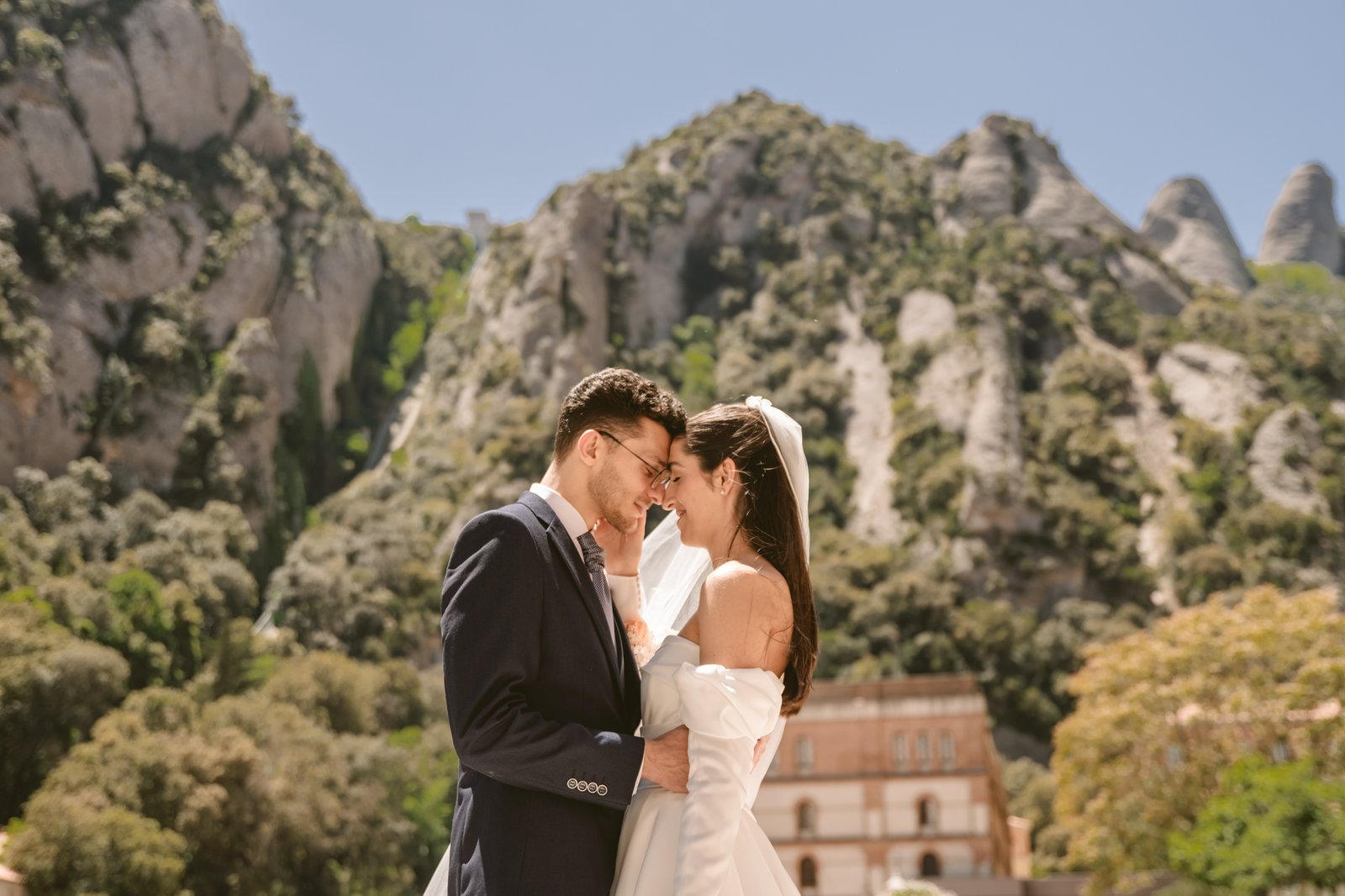Pareja de novios abrazados frente a paisaje montañoso